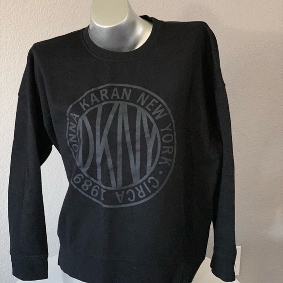 Dkny Tops - $59‼️Black DKNY top with leather logo signs size L
